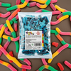 Two packs of Yummy Gummy Fizzy Blue Slices 1kg commercial marketing layout on a reflective white surface