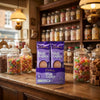 Cadburys High Lights Milk Chocolate Drink 30 x 11g Sachets displayed on a traditional wooden counter in a classic British sweet shop setting
