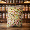 Aladdins Rainbow Twist Mallows 1kg displayed on a traditional wooden counter in a classic British sweet shop setting