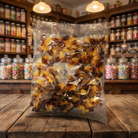 Aladdins Cola Bottles 1kg displayed on a traditional wooden counter in a classic British sweet shop setting