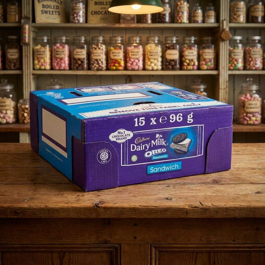 Cadburys Dairy Milk Oreo Sandwich 14 x 96g displayed on a traditional wooden counter in a classic British sweet shop setting