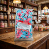 Bebeto Giant Fizzy Blue Bottles 2kg displayed on a traditional wooden counter in a classic British sweet shop setting