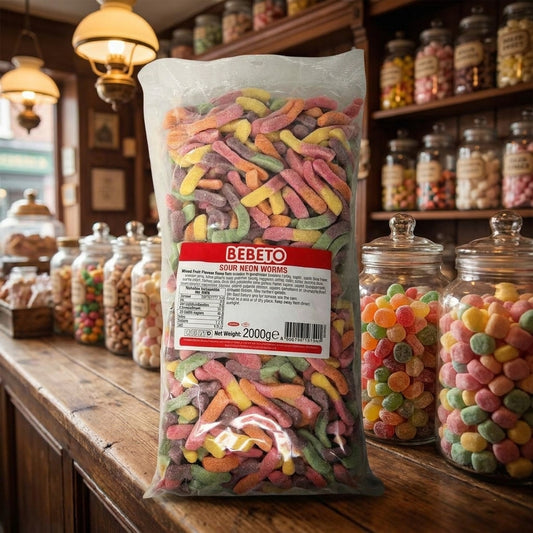 Bebeto Sour Neon Worms 2kg displayed on a traditional wooden counter in a classic British sweet shop setting