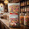 Bebeto Sour Neon Worms 2kg displayed on a traditional wooden counter in a classic British sweet shop setting
