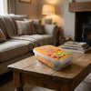 Bebeto Party Mix Tub 400g on a coffee table in a cosy home living room setting
