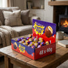 Cadburys Creme Eggs 48 x 40g on a coffee table in a cosy home living room setting