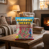 Aladdins Fizzy Twin Cherries 1kg on a coffee table in a cosy home living room setting