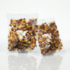 Two packs of Aladdins Cola Bottles 1kg commercial marketing layout on a reflective white surface